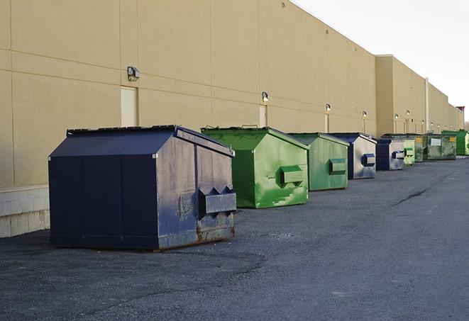 a yellow construction dumpster filled with waste materials in Amlin, OH